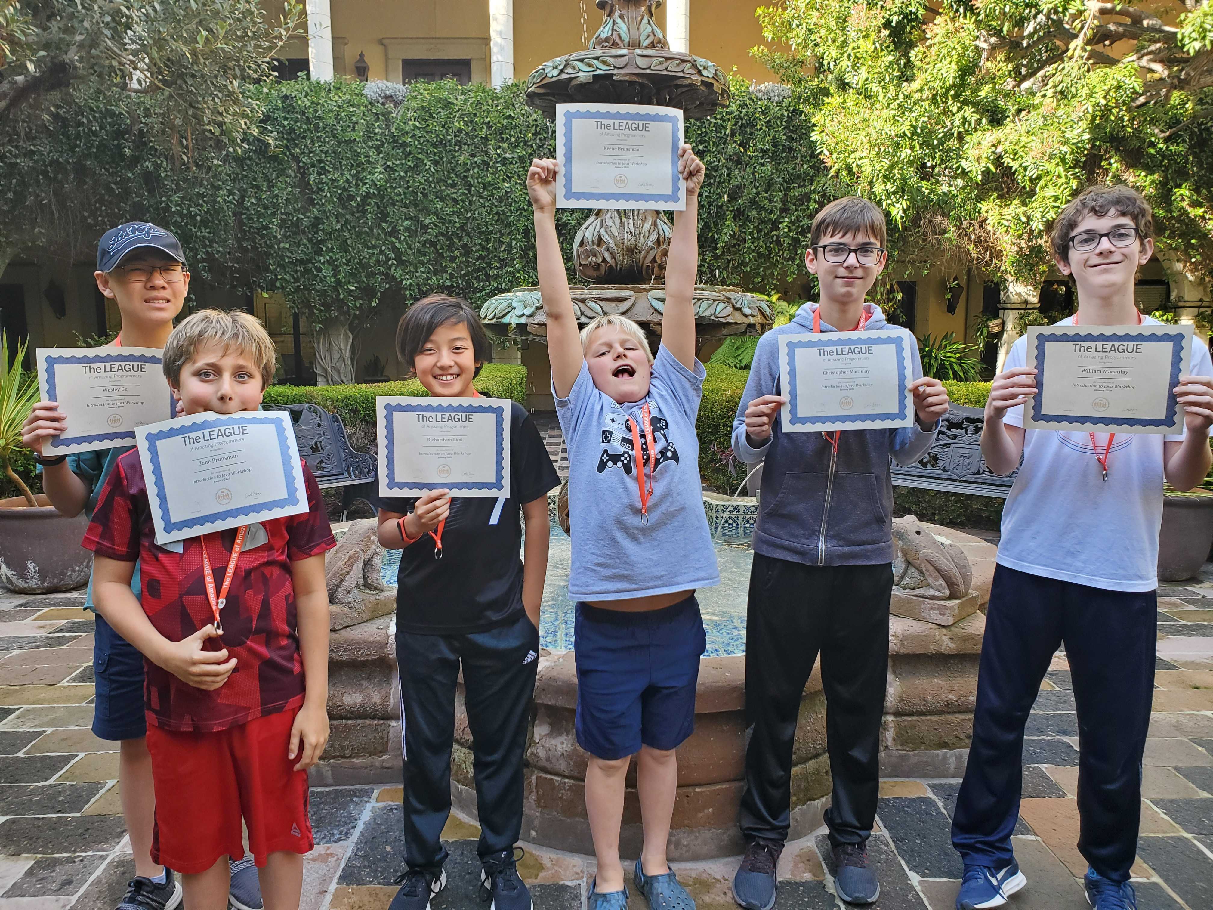 Students graduating from a League workshop